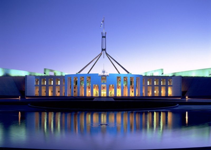 Photo of the Parliament House in Canberra. Evening photo with lights on.
